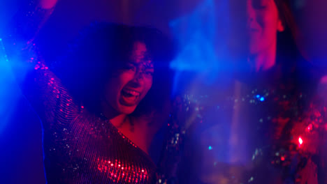 Close-Up-Of-Two-Women-In-Nightclub-Bar-Or-Disco-Dancing-With-Sparkling-Lights-7